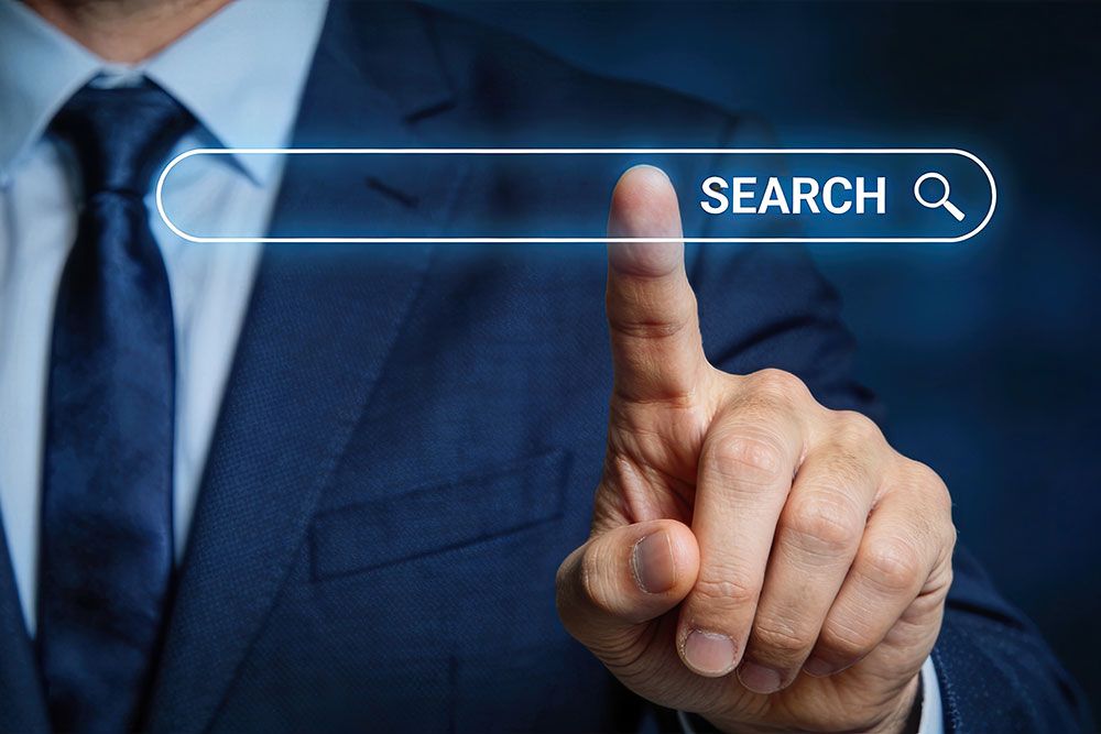 Person in a suit touching virtual search bar, symbolizing online search and digital marketing strategies.