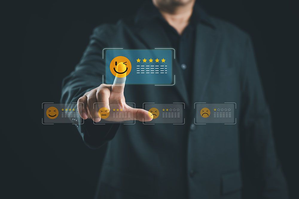 Person selecting 5-star rating with smiley face icon on virtual screen, representing excellent customer feedback.