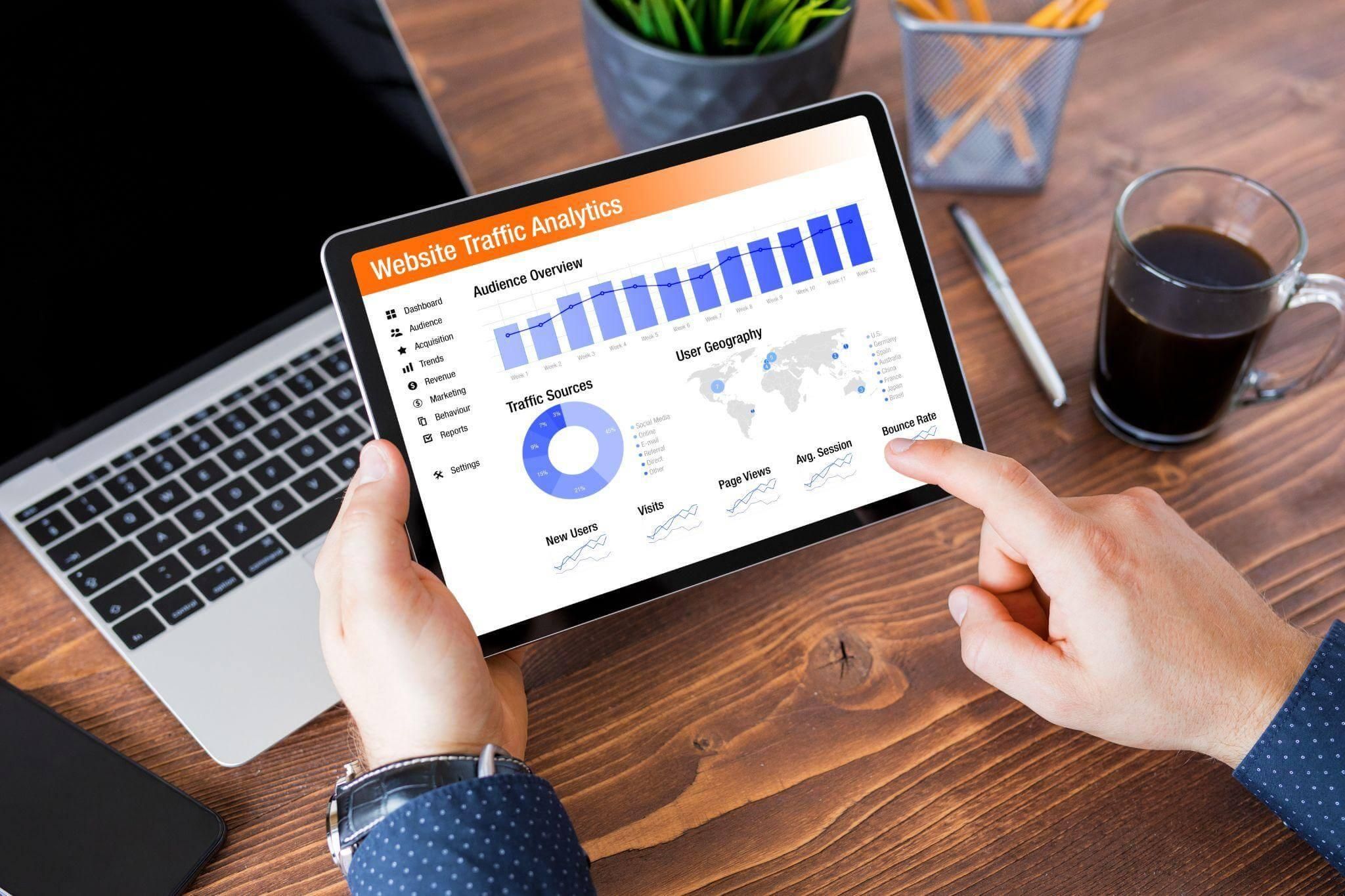 Person holding tablet displaying a chart